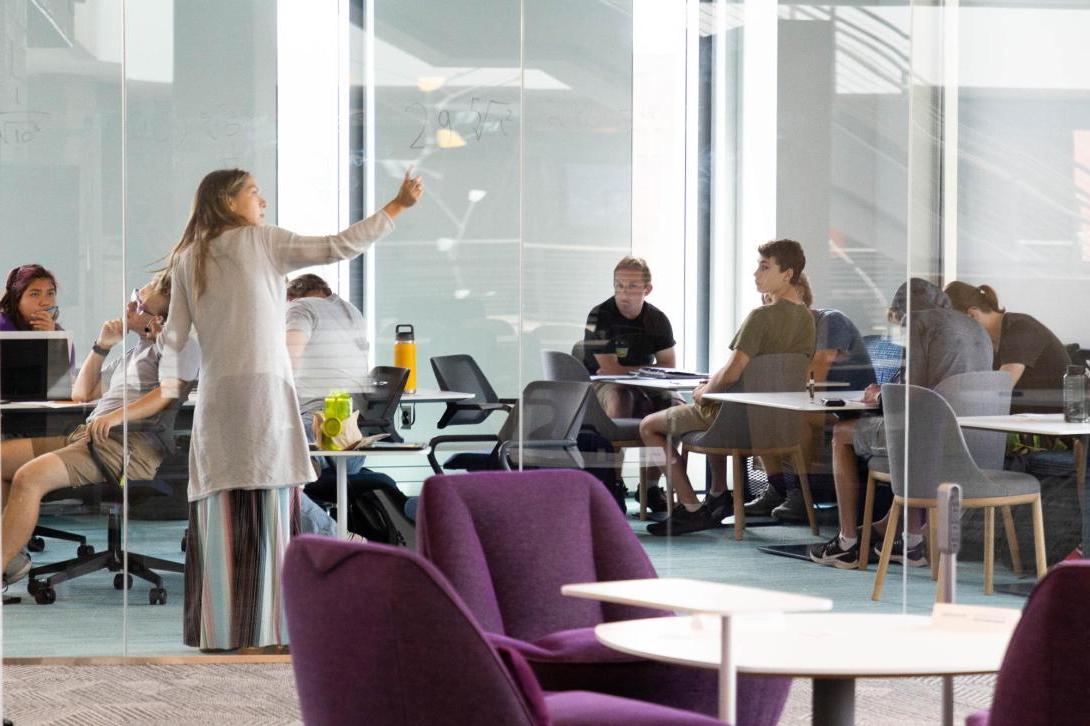 A faculty member teaches in front of a group of students in the DSpace Learning Commons