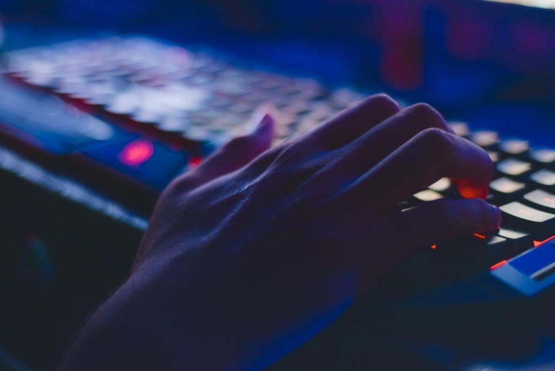 A hand typing on a keyboard